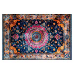 A vibrant Floral Harmony Heritage Hand Tufted Area Rug, showcasing an intricate and colorful design perfect for living rooms and dining rooms. This wool rug features a central medallion with pink and blue floral patterns against a dark background, ideal for adding a touch of elegance to boho or formal dining room settings.