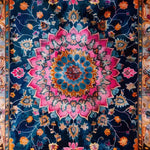 Vibrant floral area rug featuring a stunning medallion design in rich blue, pink, and orange hues. Perfect for adding a touch of elegance to your living room or dining room. This wool rug blends boho charm with formal dining room style.