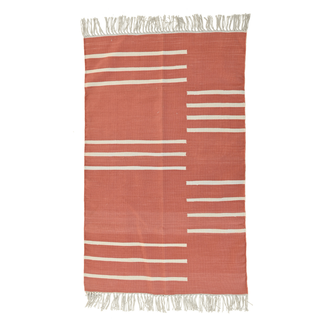 The Handwoven Orange and White Minimalistic Cotton Rug with Fringes is a stylish and contemporary addition to your living space. Crafted with precision and care, this rug showcases a minimalistic design that seamlessly blends simplicity with modern aesthetics.