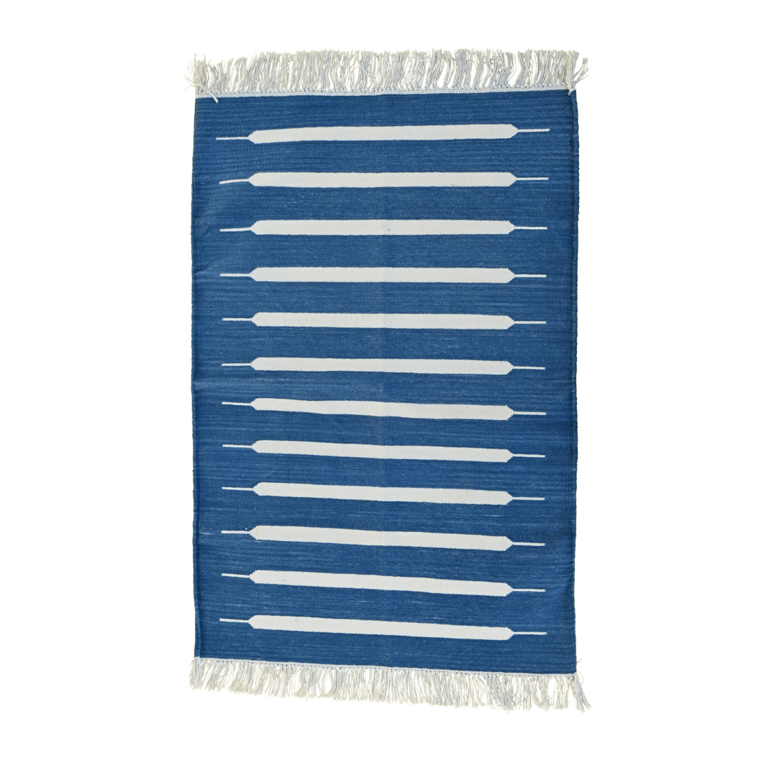 Elevate your space with the timeless elegance of the "Handwoven Blue and White Mini Stripe Cotton Rug with Fringes." Its classic mini stripe pattern in blue and white exudes sophistication, while the fringes add a charming touch. Handcrafted with care, this rug brings both style and comfort to any room in your home.