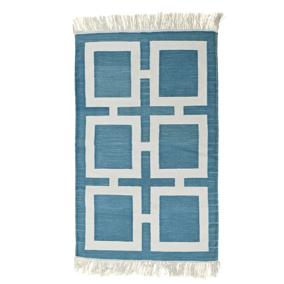 Introduce a modern flair to your space with the "Handwoven Blue and White Geometric Cotton Rug with Fringes." Its contemporary geometric design in blue and white hues adds visual interest, while the fringes provide a playful accent. Handcrafted with care, this rug brings both style and comfort to any room in your home