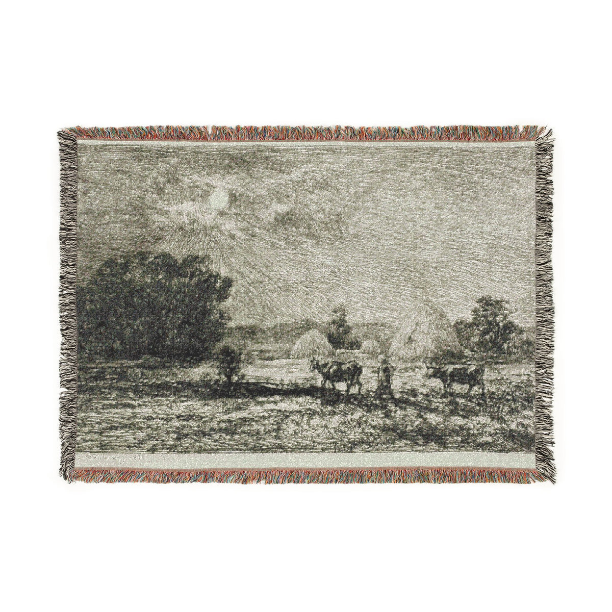 A rectangular woven throw blanket featuring a black and white landscape scene with cows and a shepherd, finished with fringed edges on all sides.