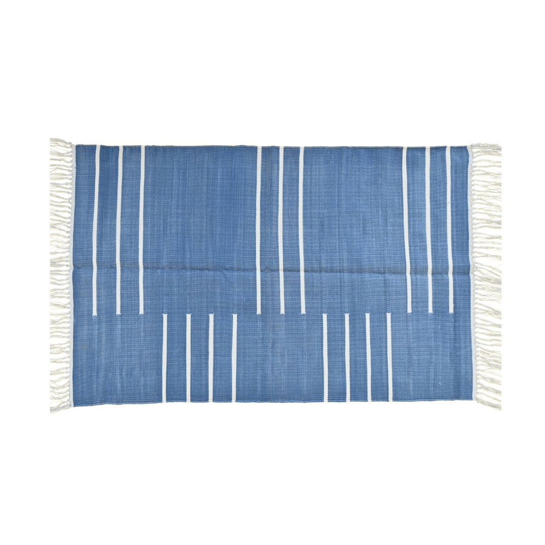 Add a touch of modern elegance to your space with the "Handwoven Blue and White Minimalistic Cotton Rug with Fringes." Its clean lines and minimalist design in blue and white hues exude sophistication, while the fringes add a subtle yet charming detail. Handcrafted with care, this rug brings a sense of tranquility and style to any room in your home.