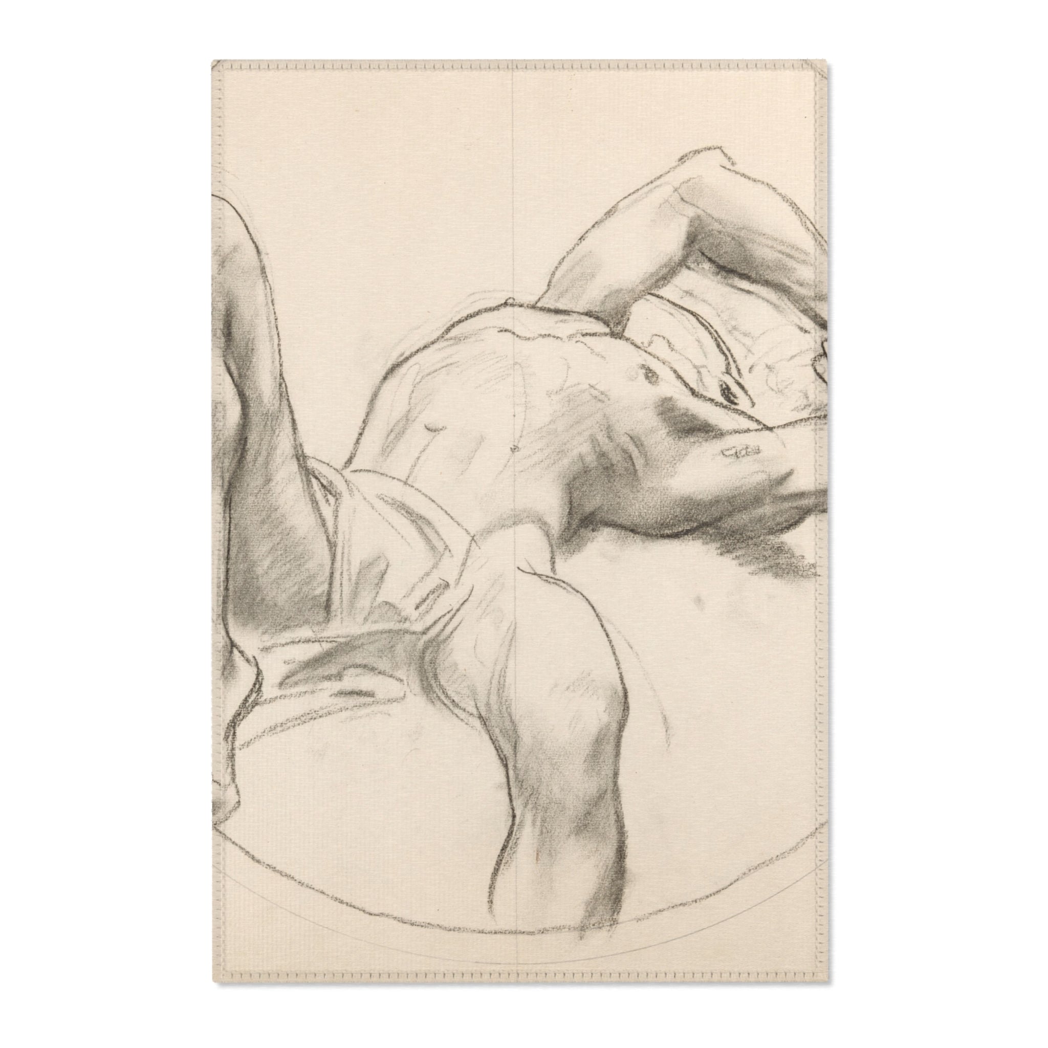A sketchbook featuring a charcoal figure drawing of a reclining male torso, shown against a plain white background.