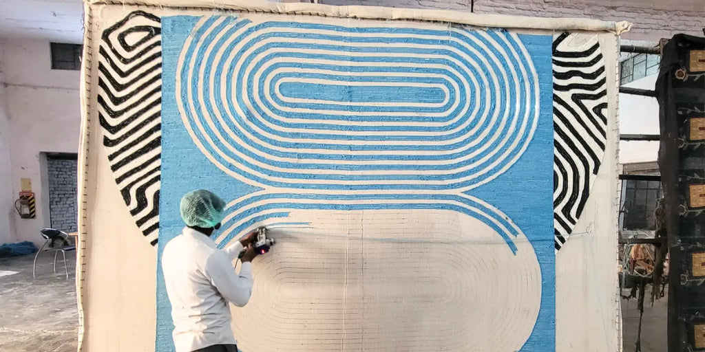 artisan tufting a large rug