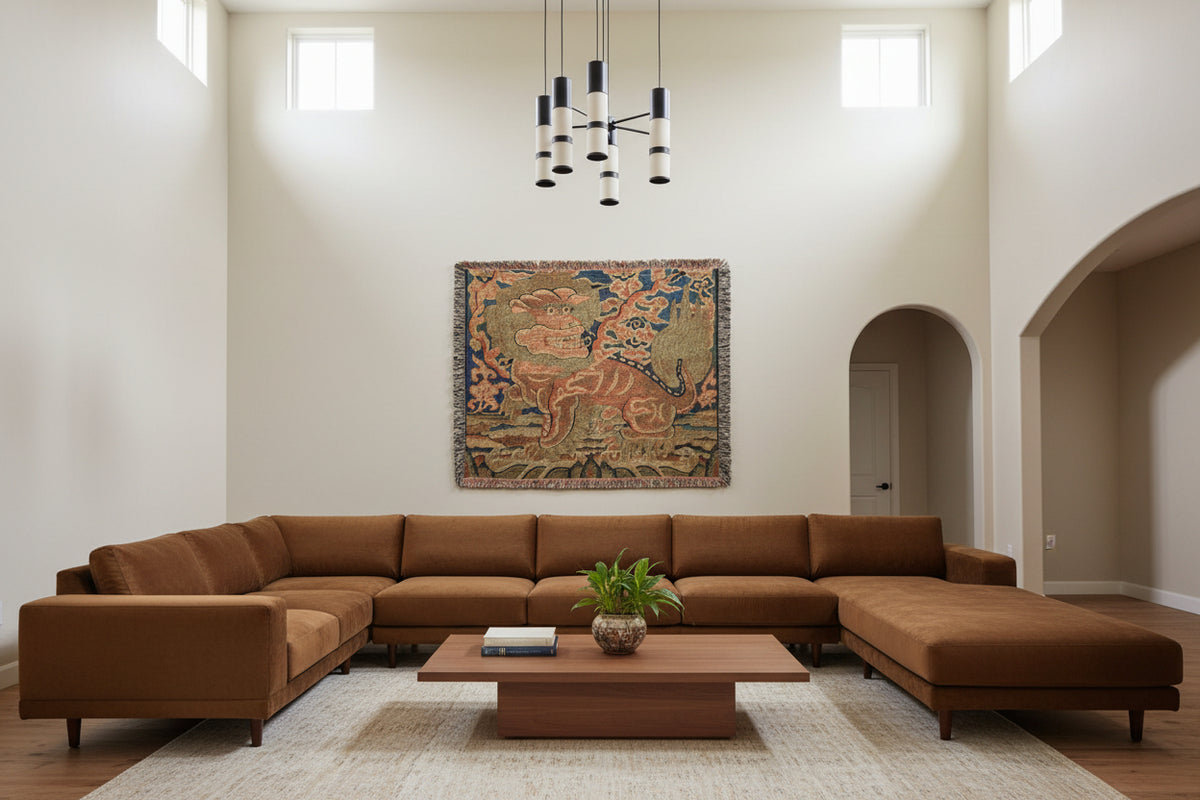 A square woven throw blanket with fringe edges, featuring a traditional Chinese-style lion motif in muted blue, beige, and terracotta tones on a white background.