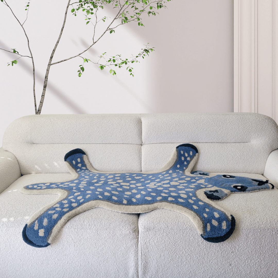 This is a hand-tufted wool rug featuring a design of deer amidst a dark blue background. The rug is made from high-quality wool, providing durability and softness underfoot. The design adds a touch of nature-inspired elegance to any room. Ideal for those seeking a cozy and stylish addition to their living space.