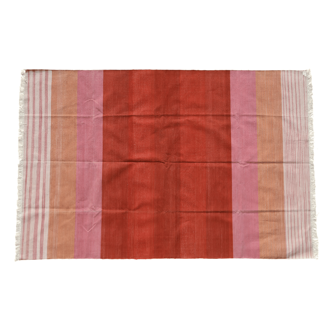 Revitalize your space with this handwoven red ombre cotton rug. Its vibrant hues transition seamlessly, infusing energy into any room. Finished with fringes for added flair, this rug brings warmth and style to your home decor.