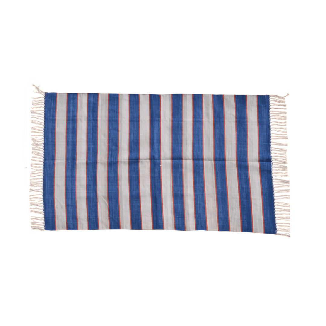Add a touch of modern flair with this handwoven blue and white bold striped cotton rug. Its striking design commands attention, while fringes provide a charming finish. Durable and soft, it effortlessly enhances your home decor with contemporary style and comfort.