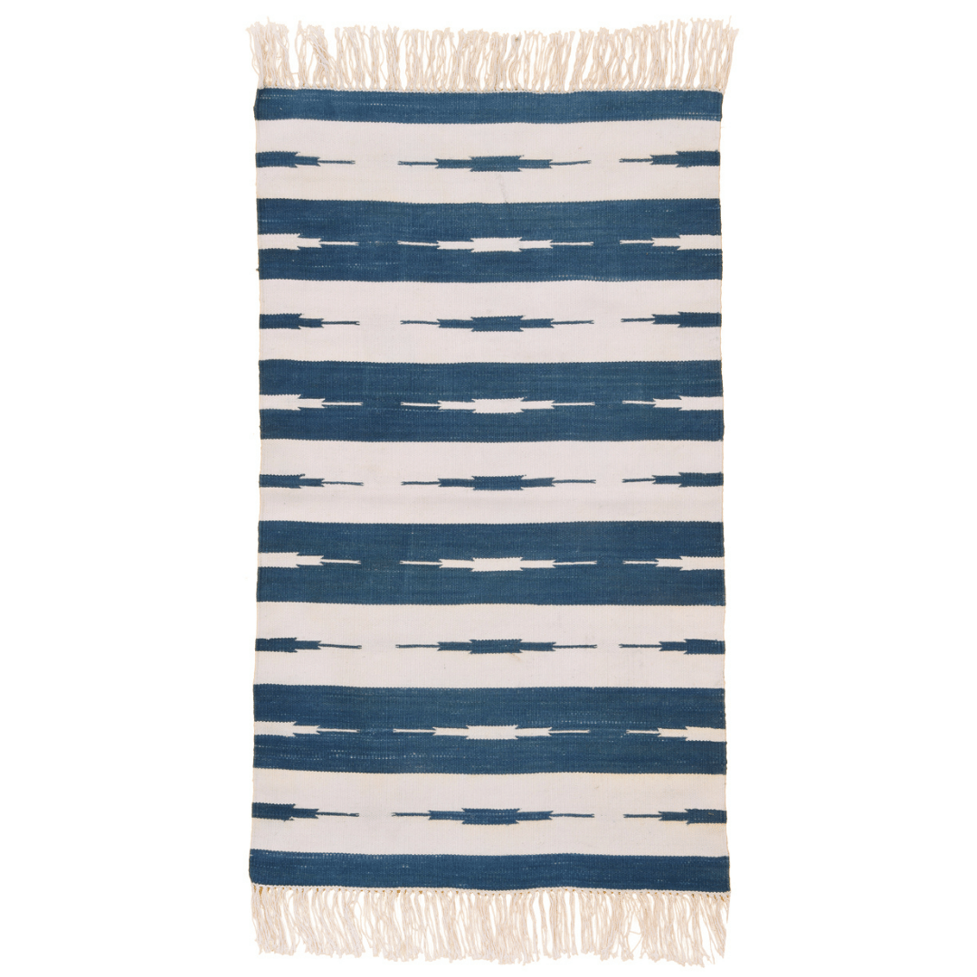 Elevate your space with this handwoven blue and white stripe Ikat cotton rug. Its intricate pattern adds depth and interest, while fringes offer a delightful accent. Durable and soft, it's a stylish addition to any room.