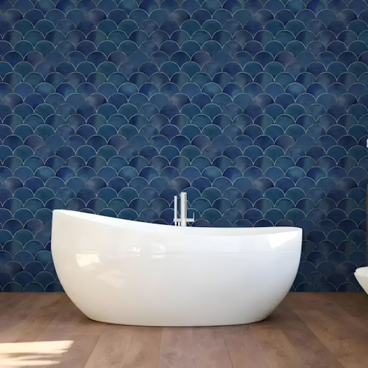 Art deco blue scallops wallpaper with gold-outlined fan shapes behind a white freestanding bathtub
