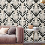 Black and white Art Deco fan wallpaper behind a blush velvet sofa and marble table