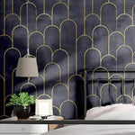 Black and gold pillars wallpaper with art deco arches in a bedroom with pendant lamp