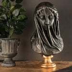 Veiled Virgin Mary bust, face visible beneath draped veil, weathered finish on gold pedestal