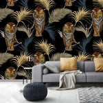 Tigers and palm leaves wallpaper on black background behind a grey sofa with gold pillows
