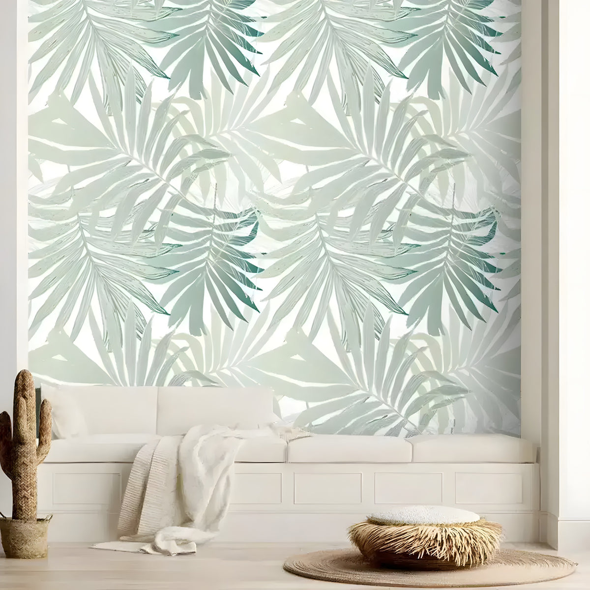 Mint green palm leaves wallpaper behind a white window bench with a cactus