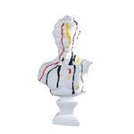 White David bust with red, yellow and black paint drips on white plinth