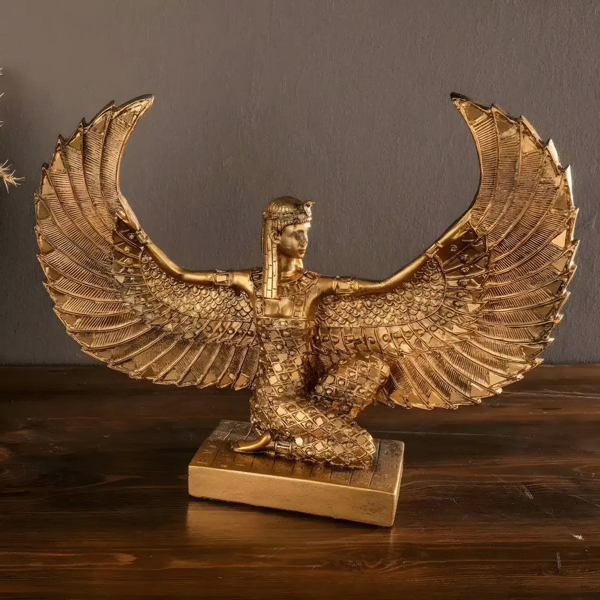 Gold kneeling Egyptian goddess Isis sculpture with outspread feathered wings on base