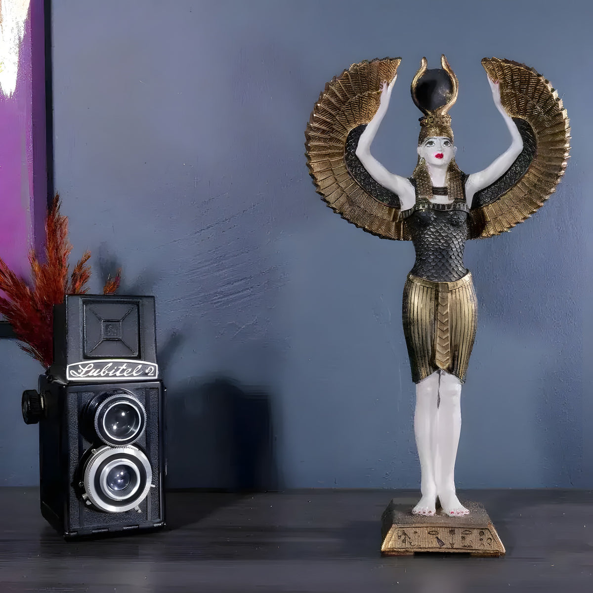 Standing winged Isis goddess statue, arms raised holding gold horned sun disk