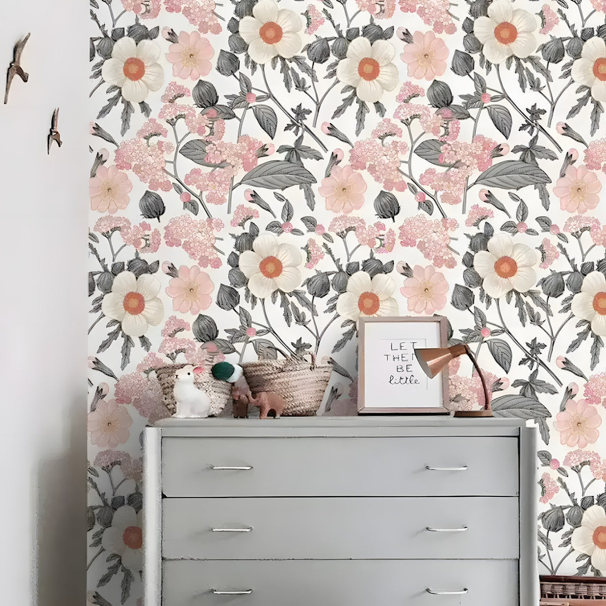 Blooming white flowers wall mural with cream blooms and pink clusters behind a grey nursery dresser