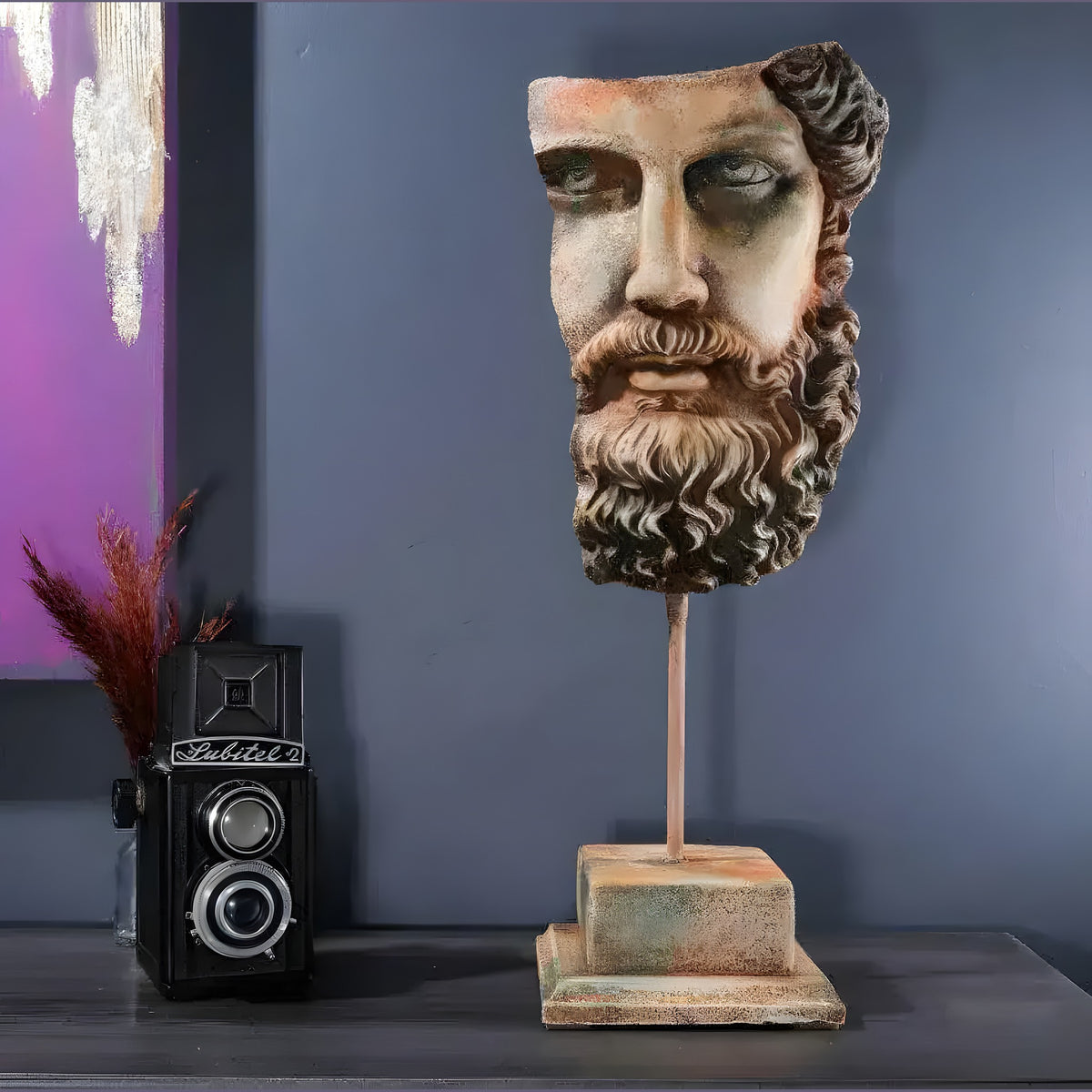 Weathered stone Zeus bust sculpture with bearded face on a rod and square base, on a dark console