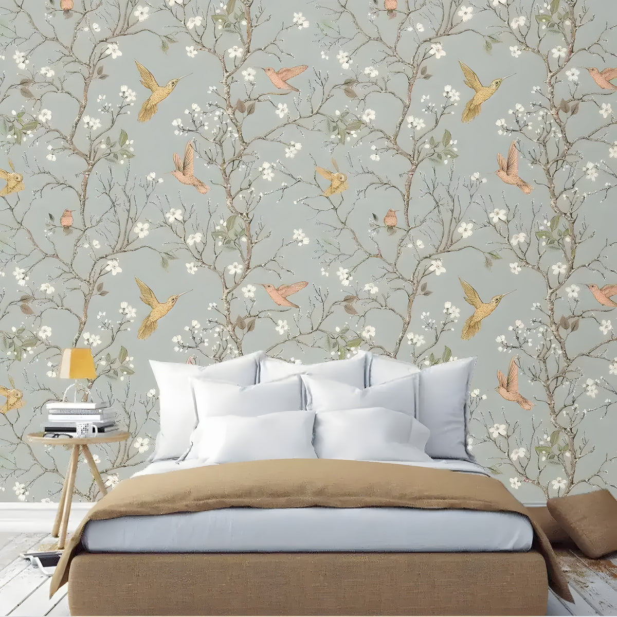 Gray chinoiserie wallpaper with branches, blossoms and birds behind a bed with tan bedding