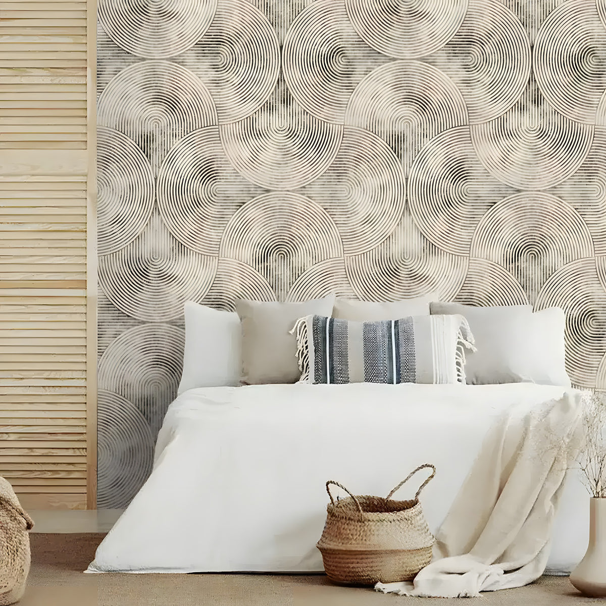 Neutral beige geometric wallpaper with concentric circles behind a white bed with throw pillows