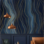 Gold abstract wave mural on deep navy behind copper pendant lamps and wainscoting