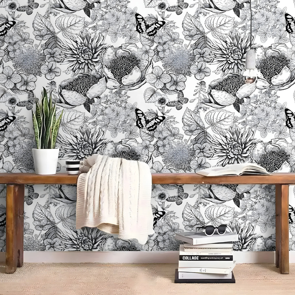 Black-and-white butterfly and floral wallpaper behind a wood bench with a knit throw