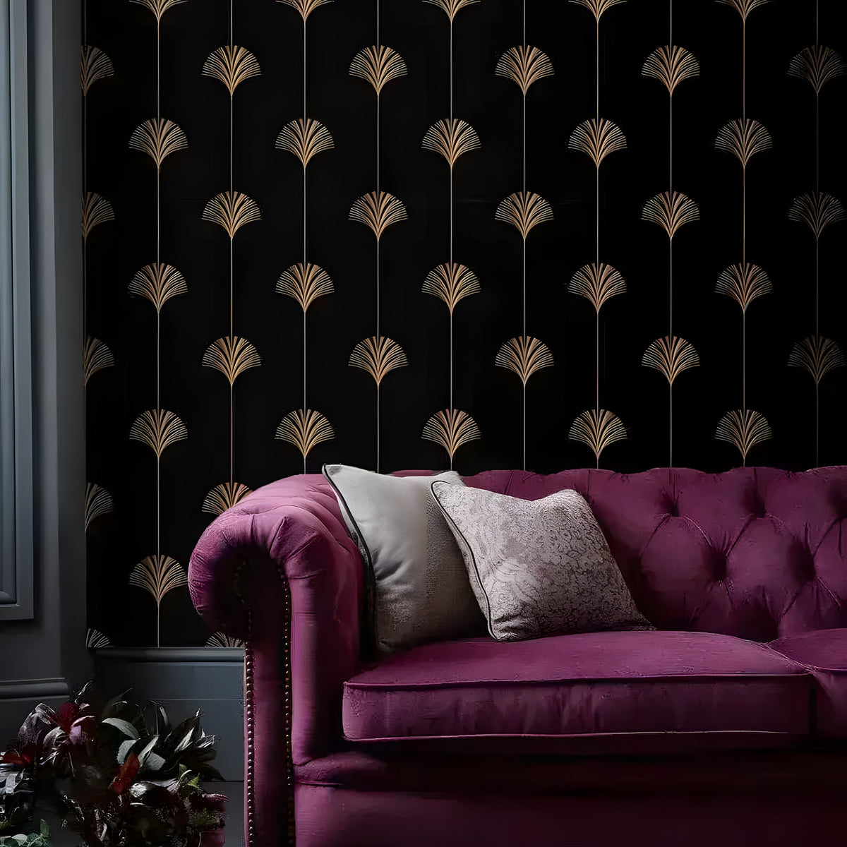 Black gold Art Deco fan wallpaper in a dark room with a burgundy velvet Chesterfield sofa