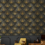 Black and gold art deco geo wallpaper with repeating gold fan palm pattern installed in a vintage-styled room