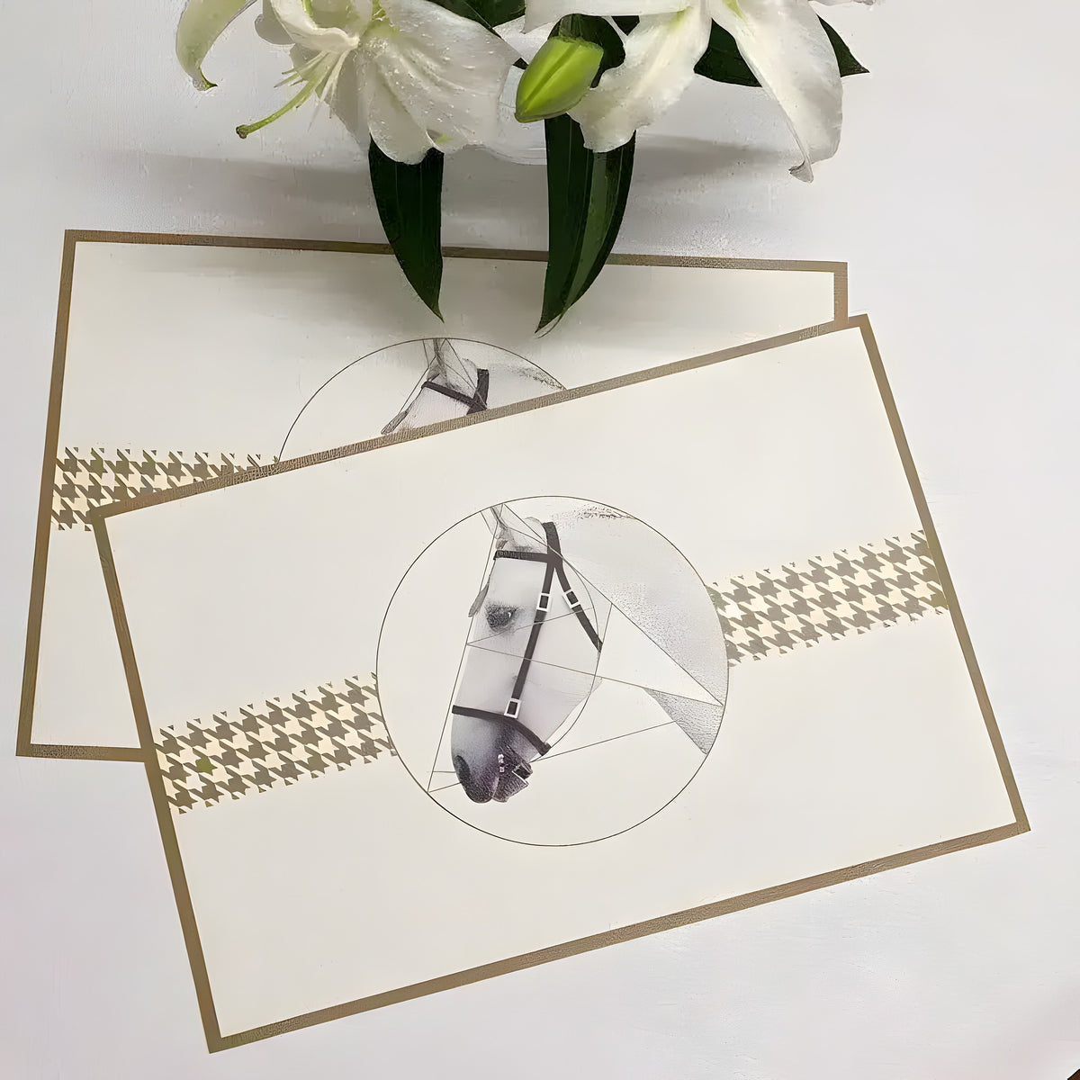 Two cream faux leather plate mats with vintage horse portrait print in circle and gold houndstooth band