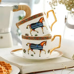 Two vintage horse bone china mugs stacked on saucer, trotting horse in colorful blanket motif, gold handles