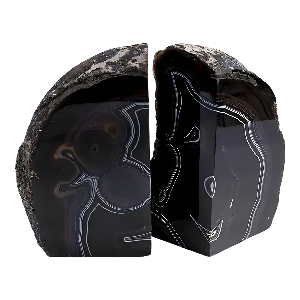 Pair of black geode crystal bookends with polished dark agate faces and white banding, rough natural exterior
