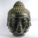 Large dark bronze single Buddha head with three faces and spiral topknot, front close-up