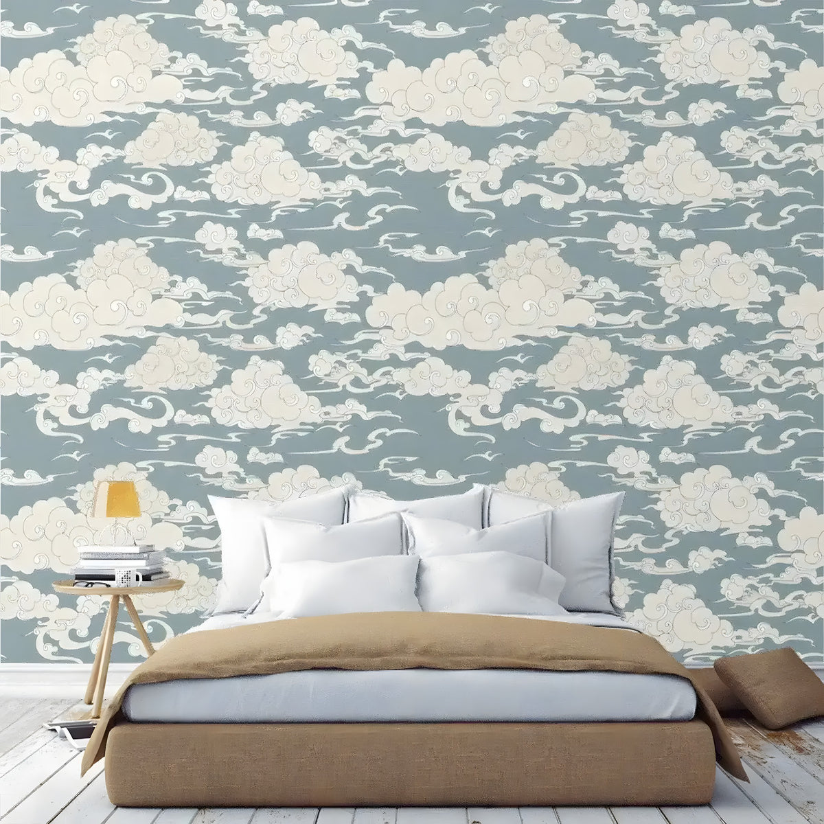 Bedroom with chinoiserie clouds wallpaper in dusty blue with swirling white cloud motifs, bed and nightstand in front