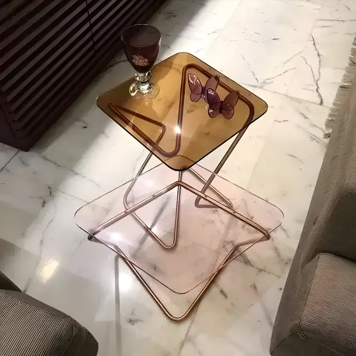 Square Crystal Table with transparent crystal side table top and brass base, on herringbone floor beside a couch