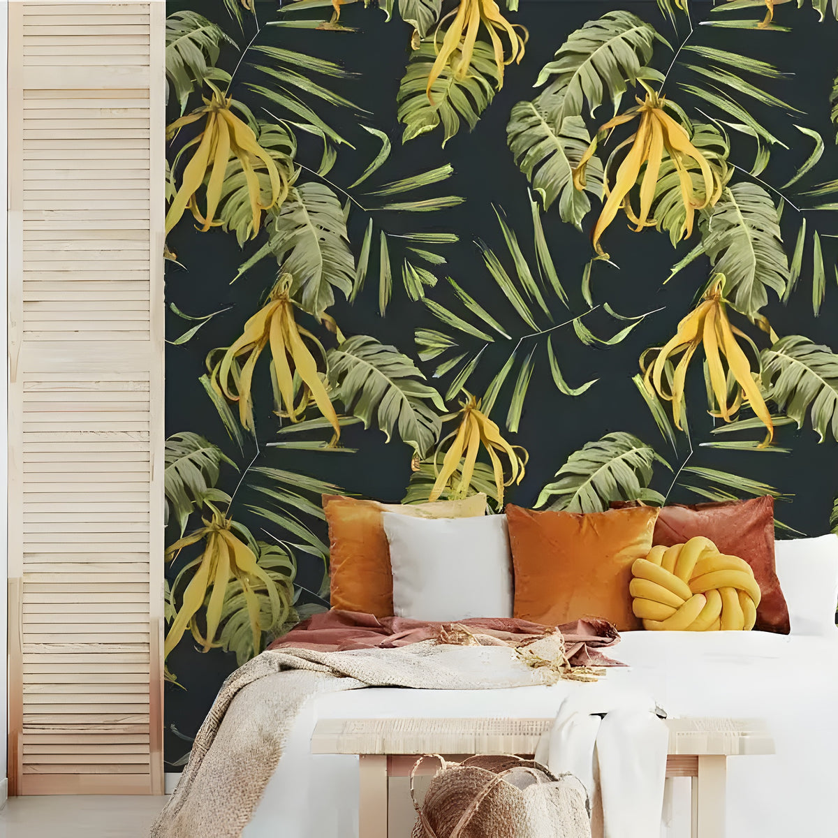 Yellow-green tropical wallpaper on bedroom accent wall — dark navy with monstera and palm leaves, white bed below