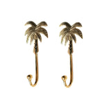 Pair of gold palm tree wall hooks with detailed frond canopy and J-hook bodies, isolated on white