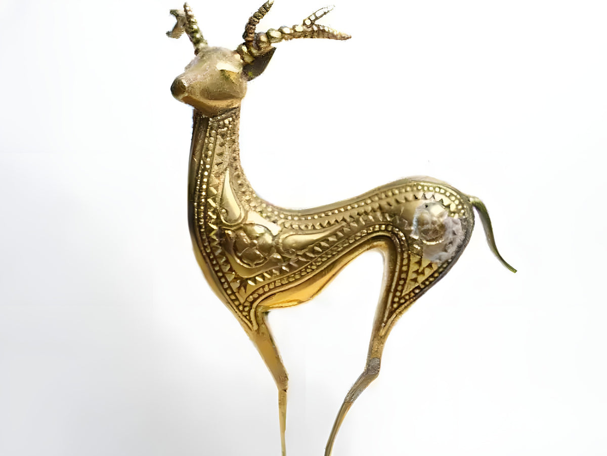 Brass deer figurine — slender antlered stag in polished gold with engraved geometric dot patterns on body