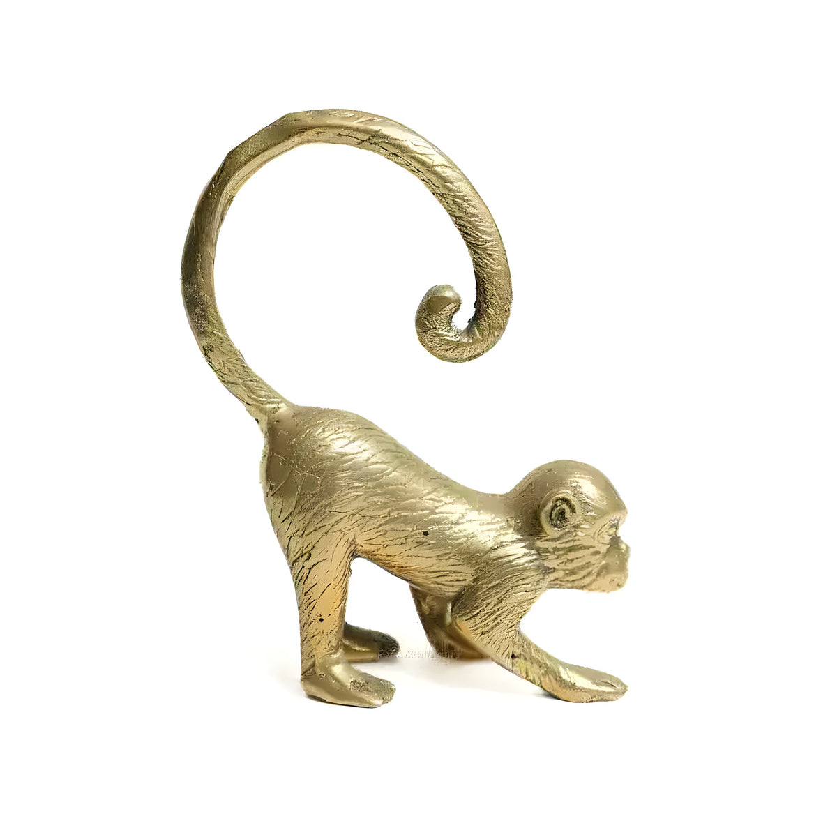 Polished gold brass monkey figurine crawling with arched curled tail, white background