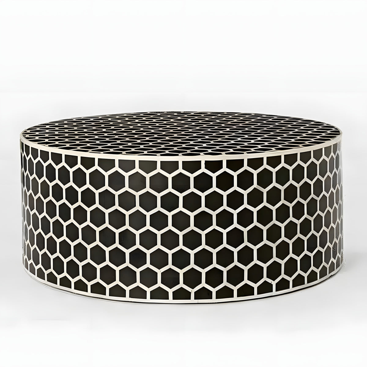 Black honeycomb bone inlay round coffee table — low drum form covered in black and white hexagons