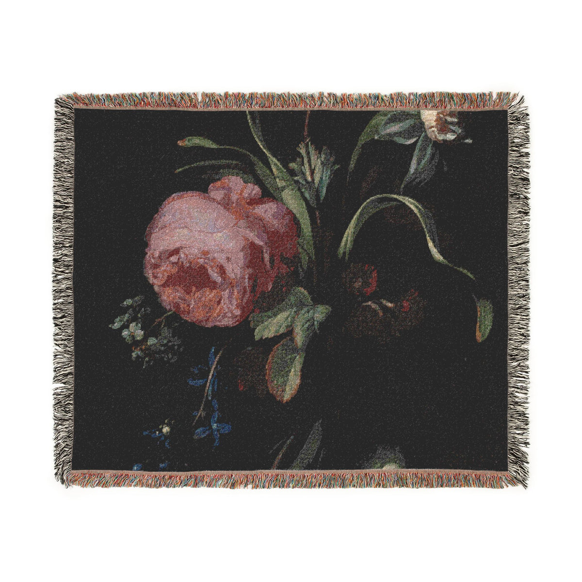 A square woven throw blanket featuring a dark floral print with a prominent pink rose, green leaves, and small blue flowers, finished with fringed edges.