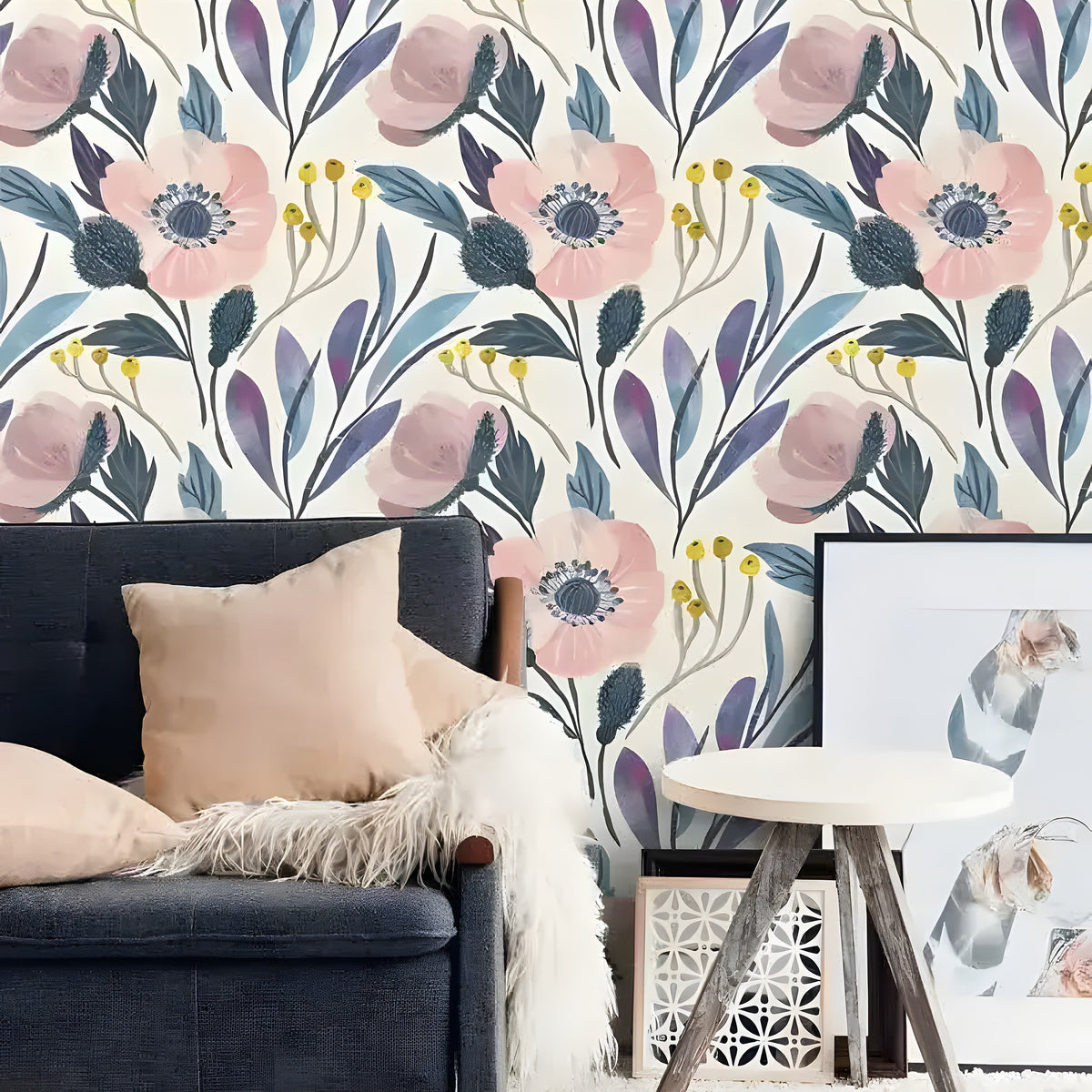 Vintage blush pink floral wallpaper in a living room, large blush poppy and blue botanical print on cream, behind dark sofa