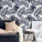 Navy Blue and White Palm Leaves wallpaper — oversized navy palm silhouettes on white, navy sofa with tan cushion and fur throw