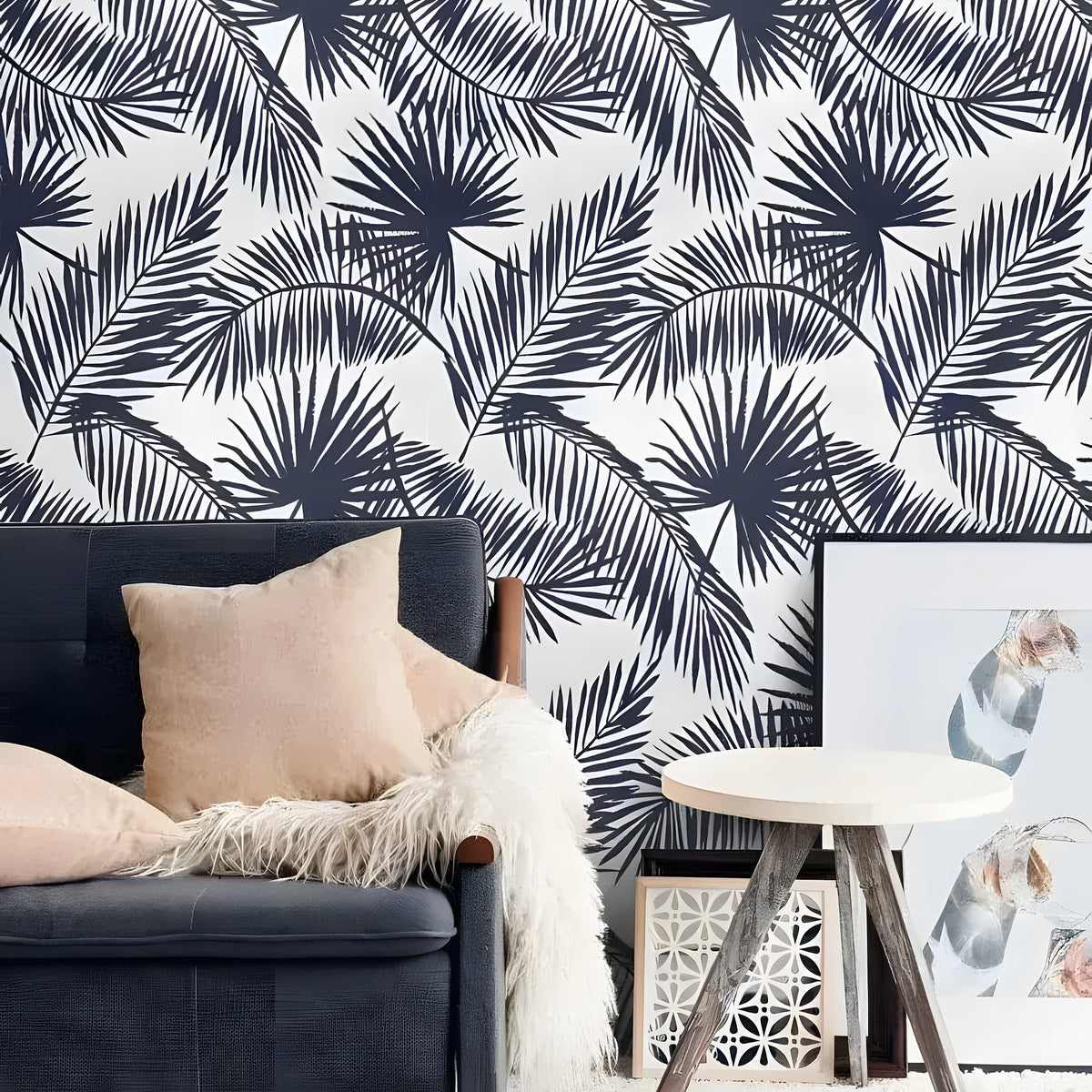 Navy Blue and White Palm Leaves wallpaper — oversized navy palm silhouettes on white, navy sofa with tan cushion and fur throw