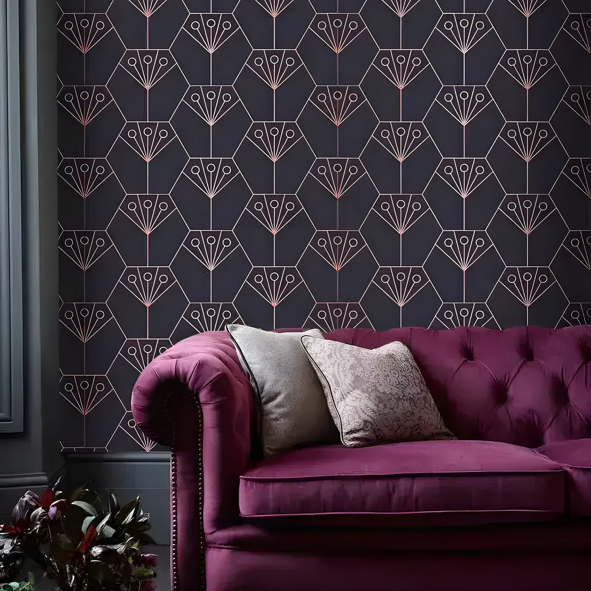 Purple Art Deco Diamonds wallpaper in dark charcoal with rose gold diamond-fan motifs, beside a tufted burgundy velvet sofa