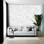 Minimalist Abstract Lines mural in a living room — white ground with flowing grey contour lines, white sofa, tropical plant