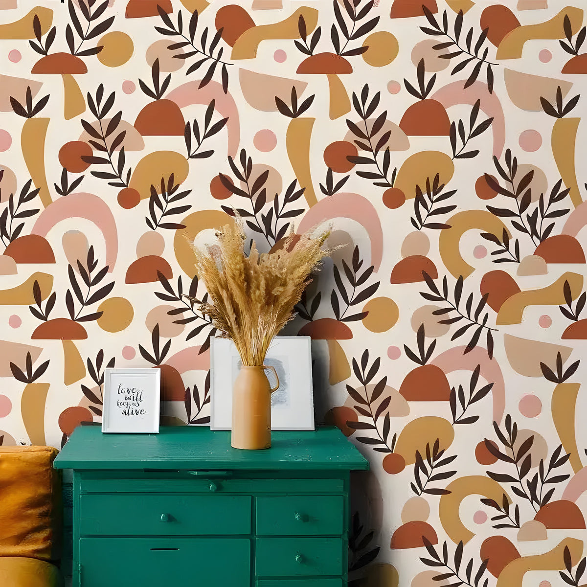 Abstract beige geometric terracotta wallpaper in a styled room with a teal dresser, dried grass vase, and warm earth-tone shapes and leaf motifs