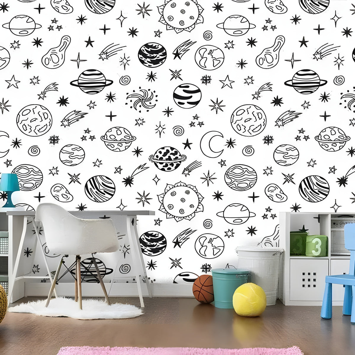 Black and white planetary celestial wallpaper in kids room with white desk and colorful toy storage